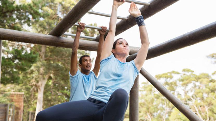 Military woman and man on monkey bars