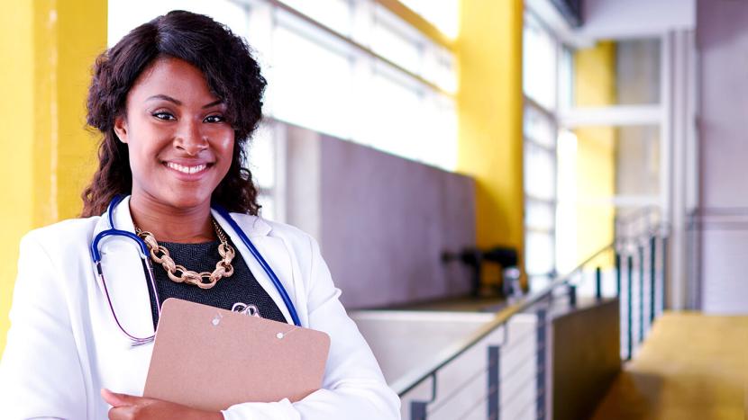African American nursing student wearing white coat and stethoscope 