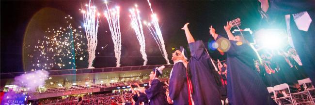 Graduates celebrating with fireworks