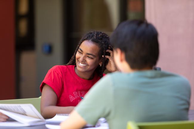 smiling student sitting at table