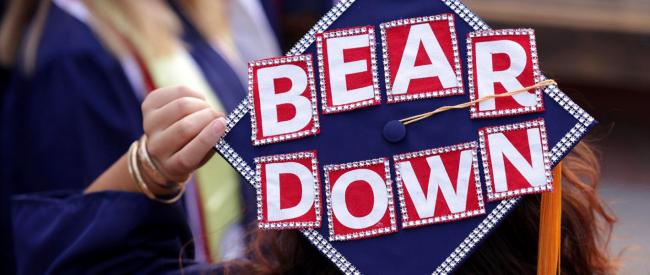 Arizona online student graduating and throwing grad cap with "bear down" written on it